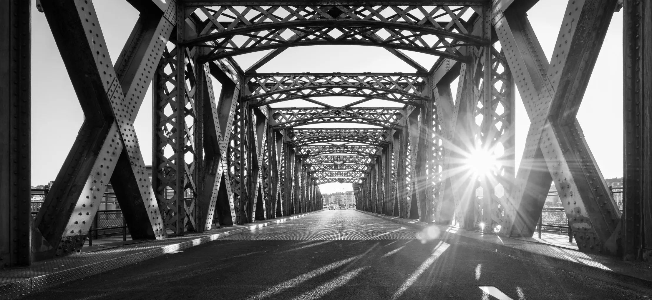 Black and white asphalt road under the steel
